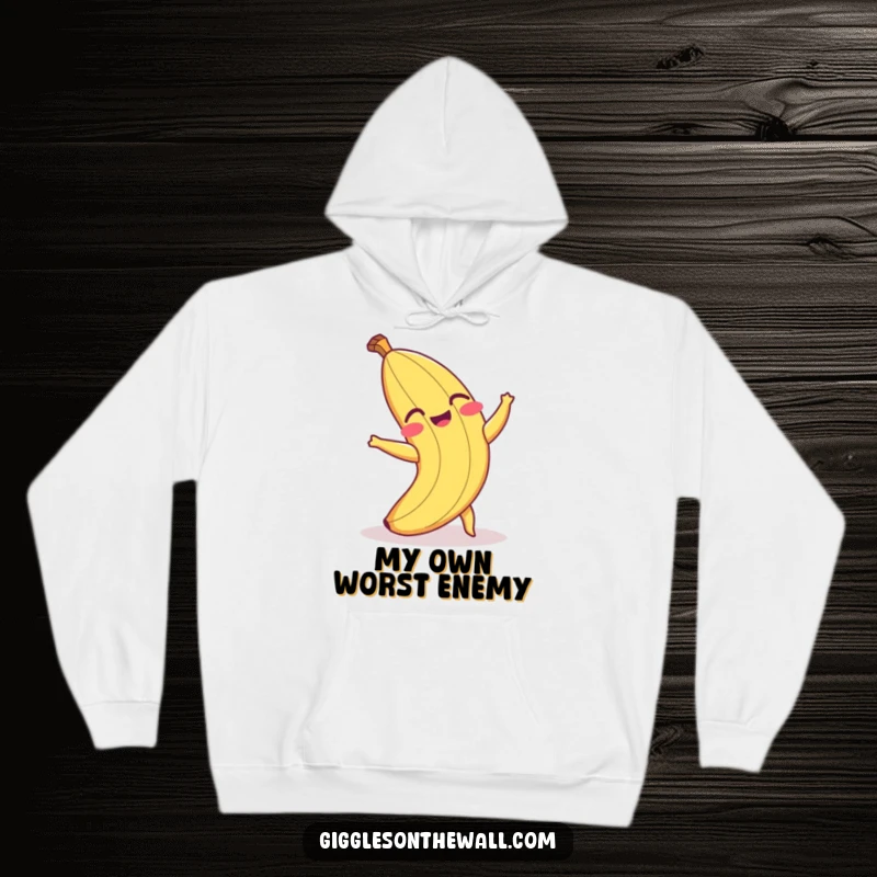 Funny hoodie depicting a laughing banana peel hilariously tripping over its own peel, emphasizing winter comfort and humor.