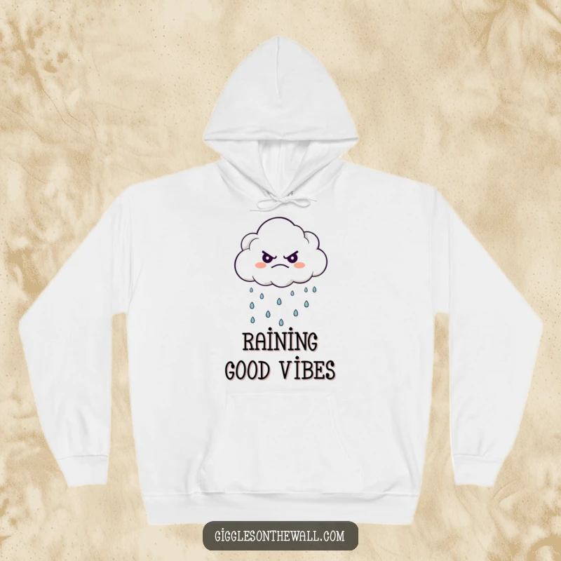 Funny hoodie with a grumpy cloud character raining happy raindrops, offering warmth and humorous contemplation.