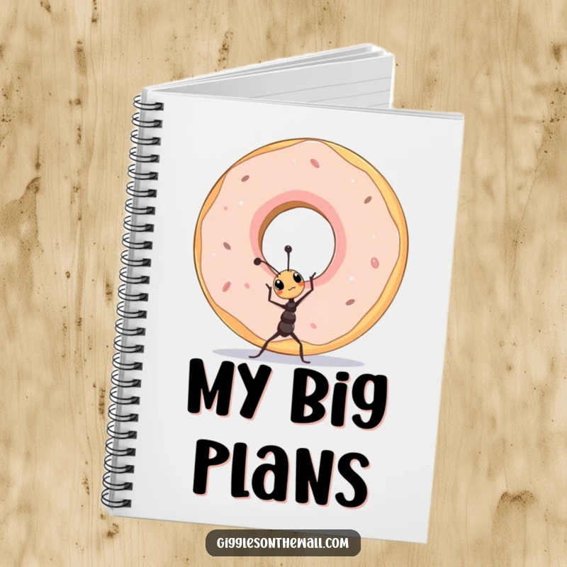 Funny tiny ant lifting a colossal donut on a notebook cover, inspiring ambitious and humorous writing.
