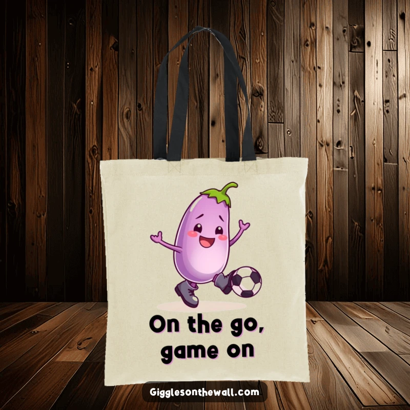 Funny tote bag displaying a smiling eggplant in boots, actively kicking a football, a humorous carry-all companion.